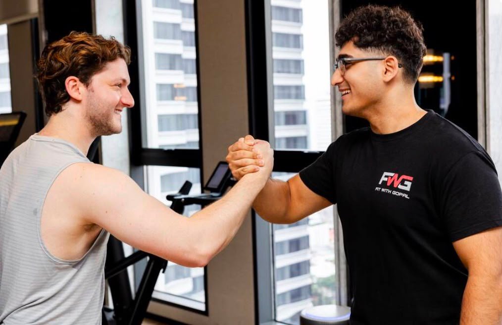 Coach and client shaking hands after a one-on-one personal training session in Bangkok